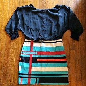 Dress with loose sleeves black blouse and tight bold colorful skirt bottom